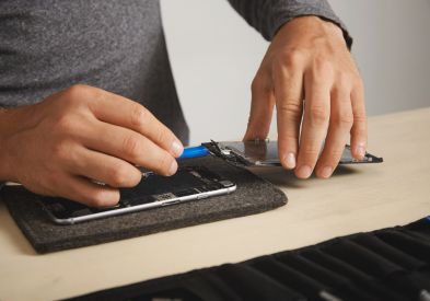 Technician repairing a smartphone screen at Al Barsha Electronics Dubai